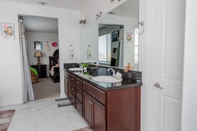 full bath with marble finish floor, visible vents, a sink, and double vanity