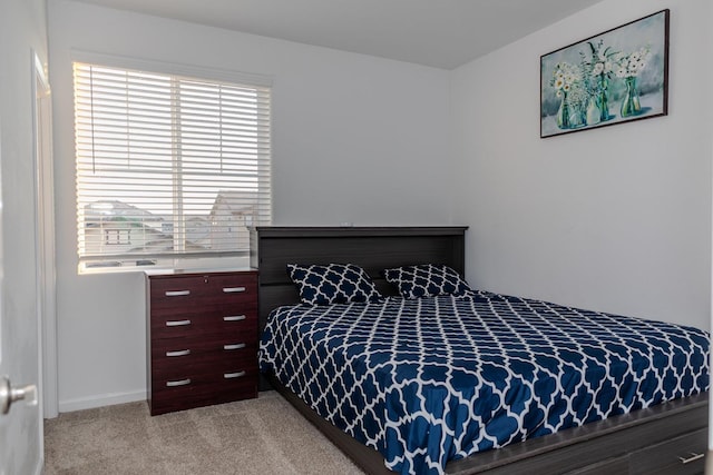 bedroom featuring light colored carpet