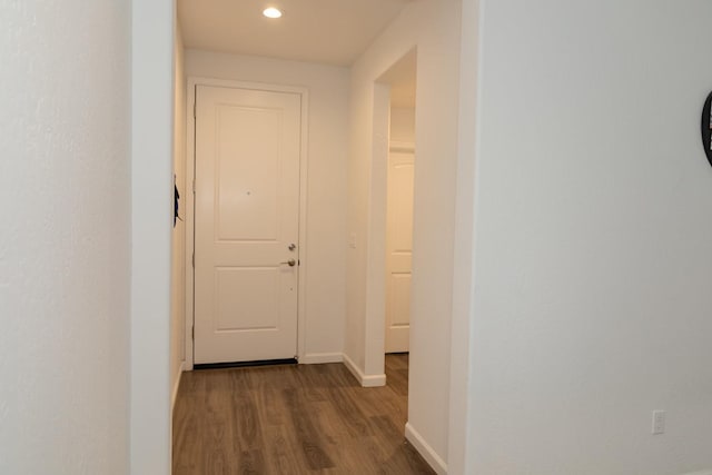 corridor featuring recessed lighting, dark wood finished floors, and baseboards