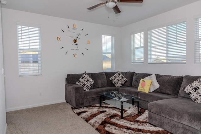 living room featuring a ceiling fan, a healthy amount of sunlight, carpet flooring, and baseboards