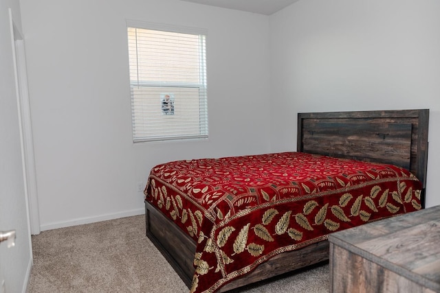 bedroom featuring light carpet and baseboards