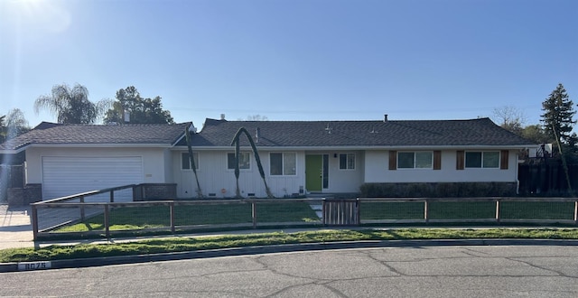 ranch-style house with a garage, a front lawn, a fenced front yard, and stucco siding