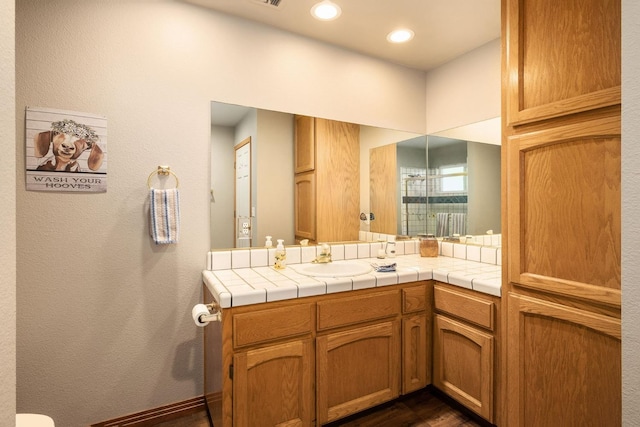 bathroom with vanity and recessed lighting