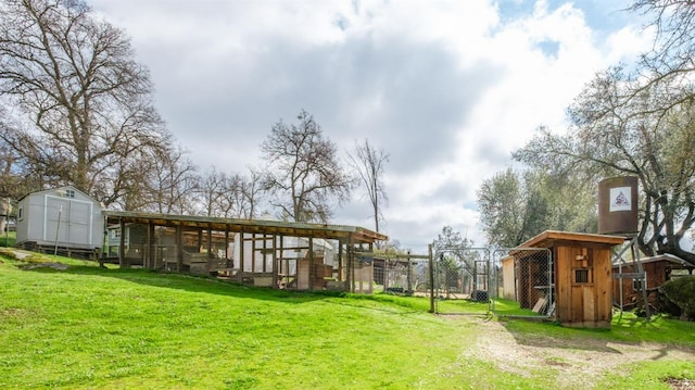 view of yard featuring an outdoor structure and fence