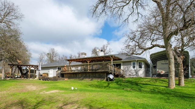 rear view of house featuring a deck, a lawn, and a detached carport