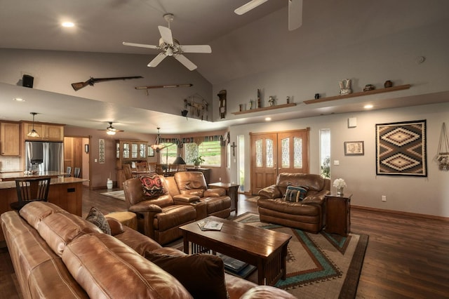 living area featuring a ceiling fan, dark wood finished floors, and high vaulted ceiling