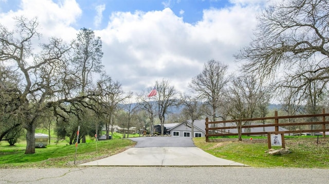 view of road featuring concrete driveway