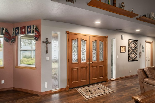 entrance foyer featuring dark wood-type flooring, recessed lighting, visible vents, and baseboards