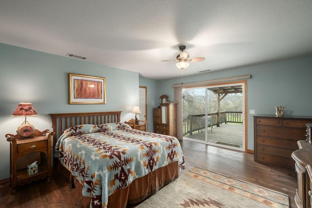 bedroom featuring visible vents, a ceiling fan, dark wood-style floors, access to exterior, and a textured ceiling