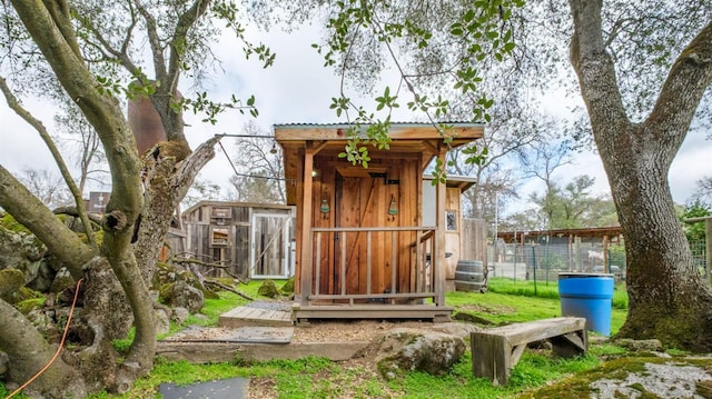 view of outdoor structure featuring fence