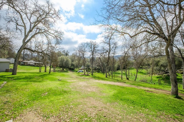 view of community with a yard and driveway