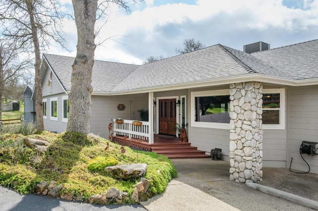 view of front of property featuring a porch and roof with shingles