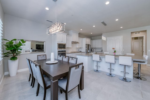 dining space with recessed lighting, visible vents, and baseboards