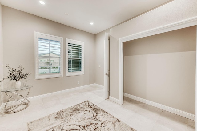 interior space featuring baseboards and recessed lighting