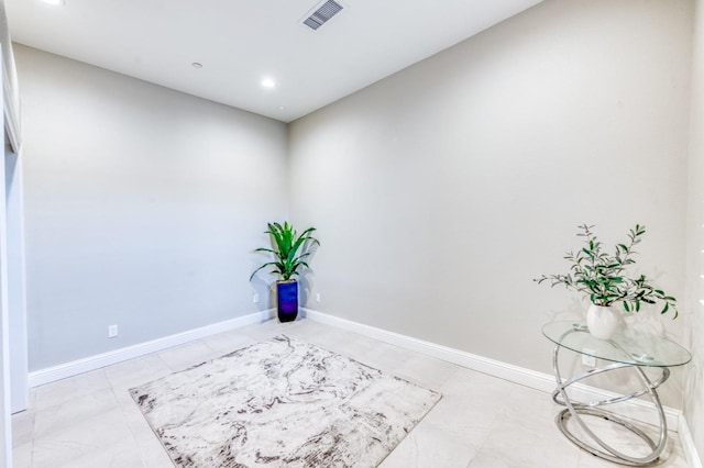 unfurnished room with baseboards, visible vents, and recessed lighting