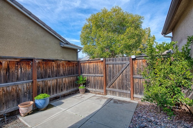 view of patio featuring a gate and fence