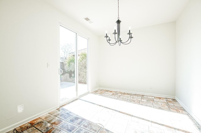 unfurnished dining area featuring a chandelier, visible vents, and baseboards