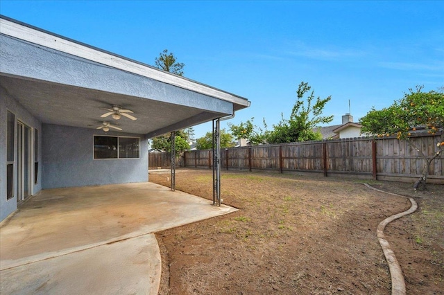 view of yard featuring a ceiling fan, a fenced backyard, and a patio