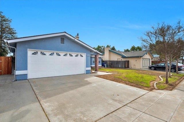 single story home with an attached garage, fence, driveway, stucco siding, and a front yard