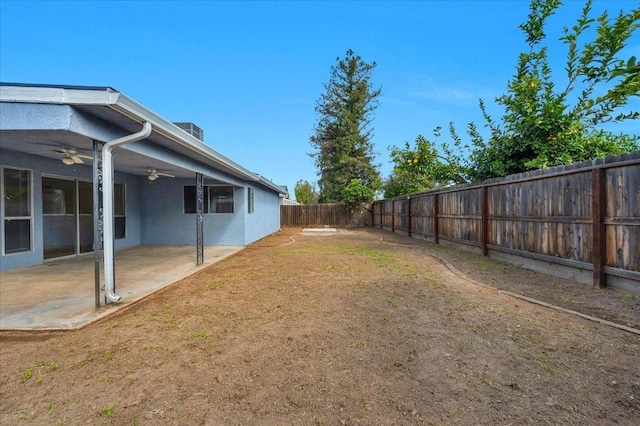 view of yard featuring a ceiling fan, a fenced backyard, and a patio