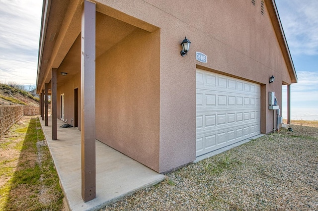 36105 Cressman Rd, Shaver Lake, CA 93664 - view of side of home with a garage, stucco siding, and fence