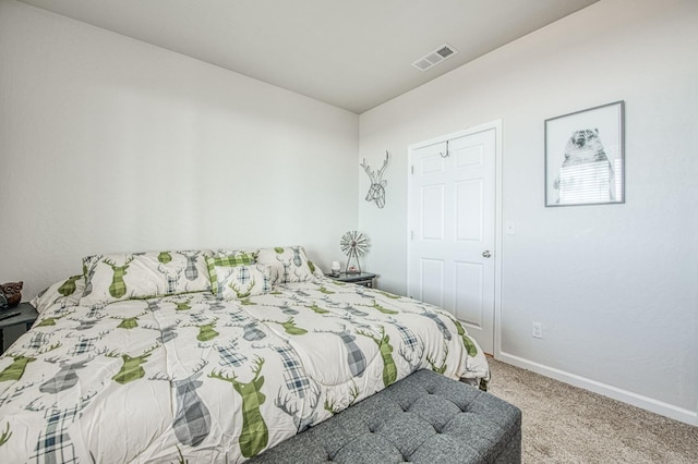 carpeted bedroom featuring baseboards and visible vents