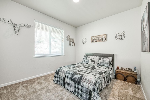 carpeted bedroom featuring baseboards