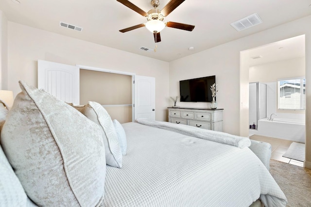 tiled bedroom featuring a ceiling fan, visible vents, and connected bathroom