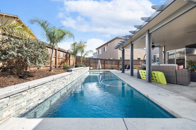 view of swimming pool with a patio area, a fenced backyard, ceiling fan, and a fenced in pool