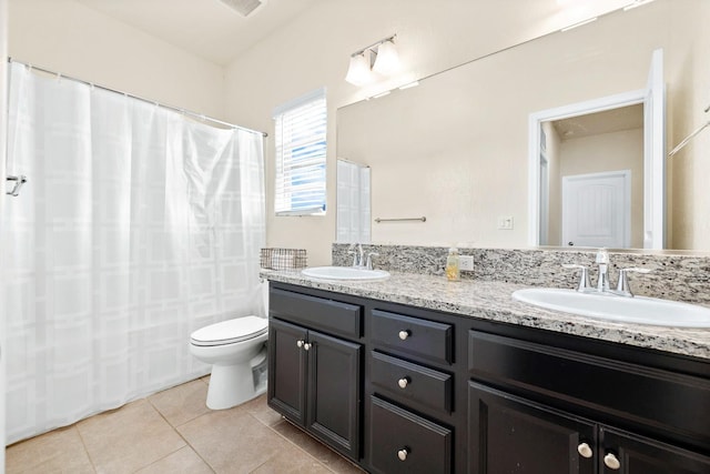 full bathroom with tile patterned flooring, a sink, toilet, and double vanity