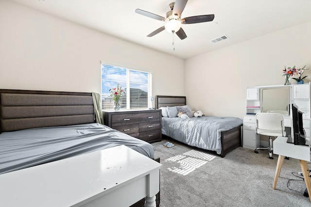 bedroom featuring light carpet, visible vents, and a ceiling fan