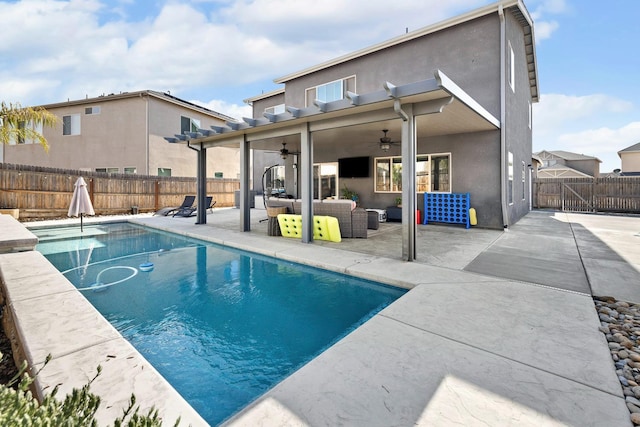 view of pool with a patio area, a fenced backyard, an outdoor hangout area, and a ceiling fan