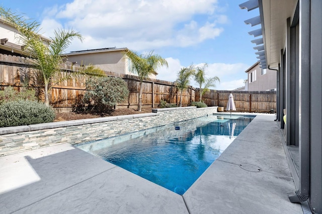 view of pool featuring a fenced in pool, a fenced backyard, and a patio