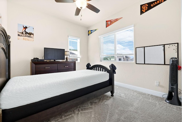 carpeted bedroom with lofted ceiling, baseboards, and a ceiling fan