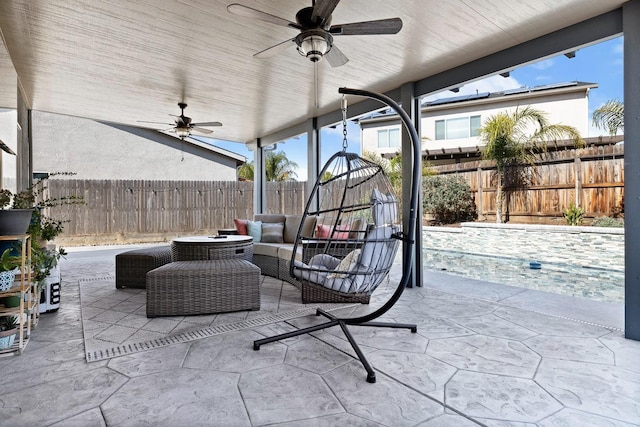 view of patio featuring ceiling fan, an outdoor hangout area, and a fenced backyard