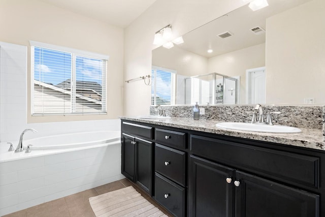 bathroom with visible vents, a sink, a shower stall, tile patterned flooring, and a bath