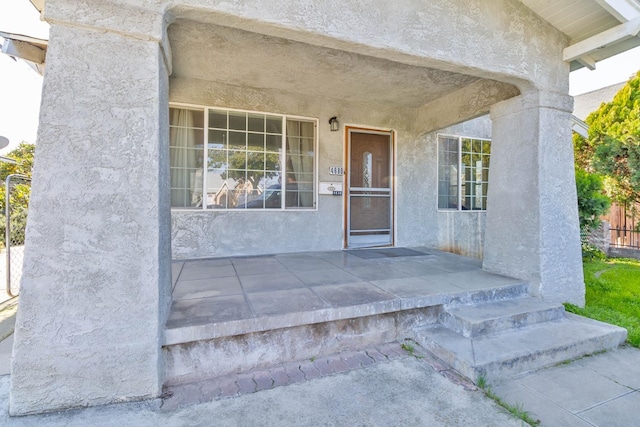 entrance to property with stucco siding