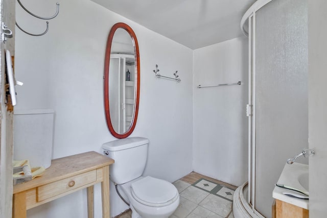 full bath featuring a stall shower, vanity, and toilet