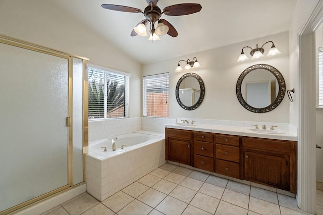 bathroom with a stall shower, a garden tub, tile patterned flooring, vaulted ceiling, and a sink