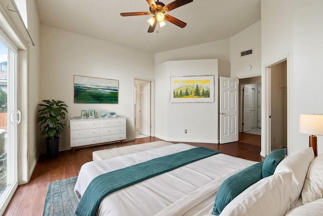 bedroom with high vaulted ceiling, visible vents, ceiling fan, and wood finished floors