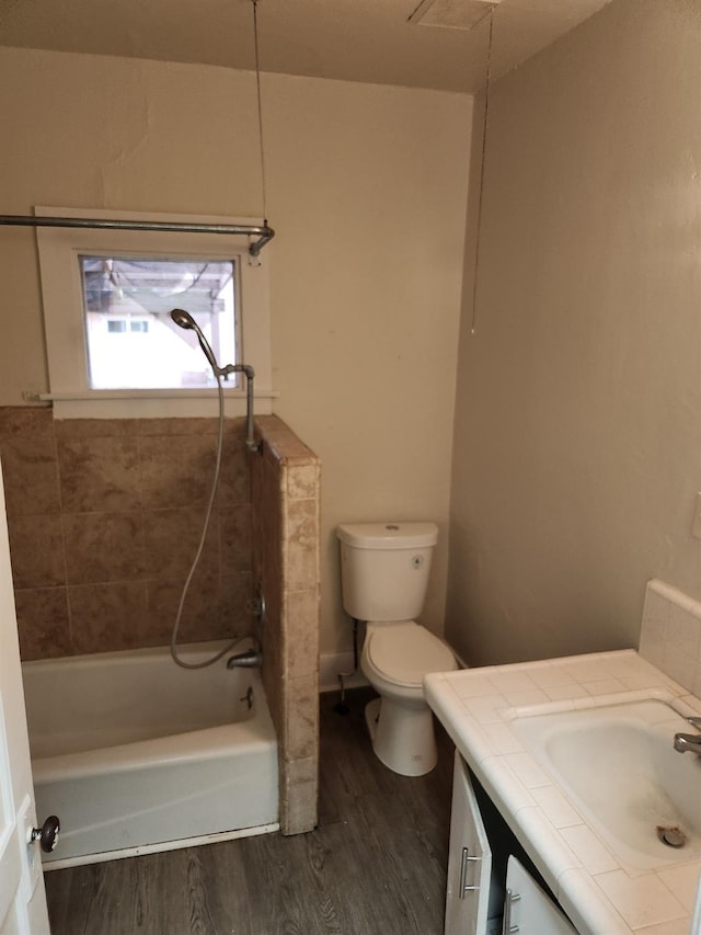 full bath featuring toilet, shower / bathing tub combination, wood finished floors, and vanity