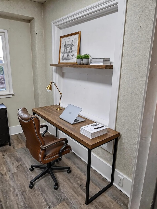 office space featuring baseboards and wood finished floors