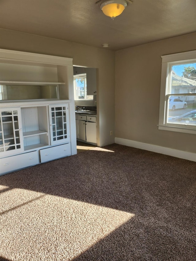 spare room with carpet floors and baseboards