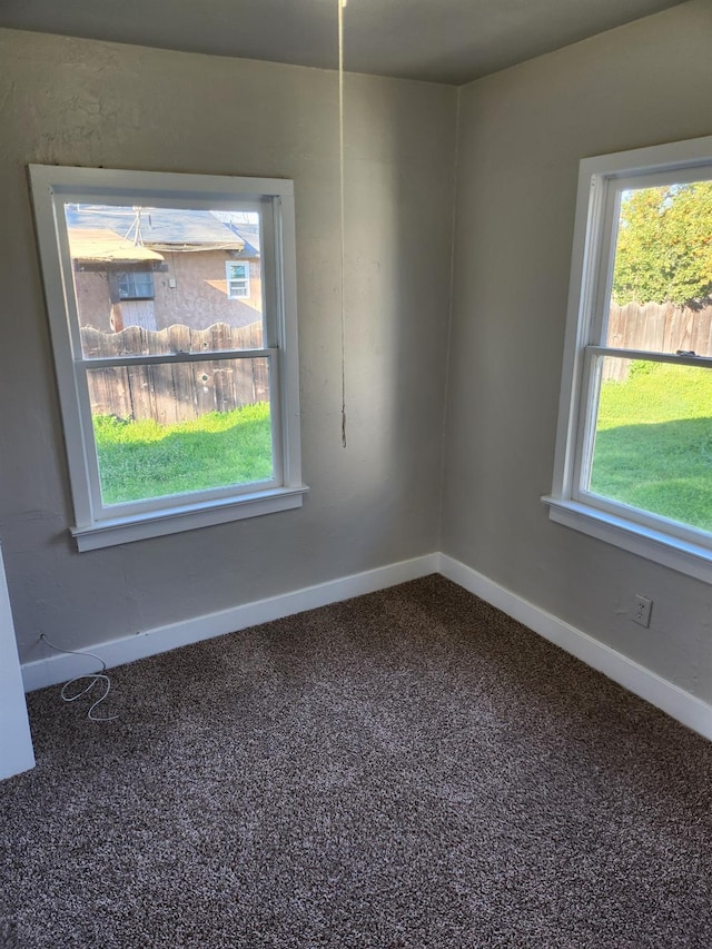 spare room with carpet and baseboards