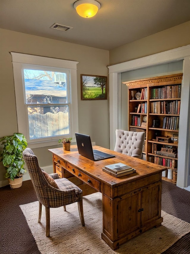 carpeted office space with visible vents