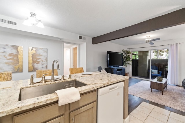 kitchen with beam ceiling, visible vents, open floor plan, a sink, and dishwasher