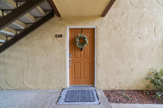 property entrance with stucco siding