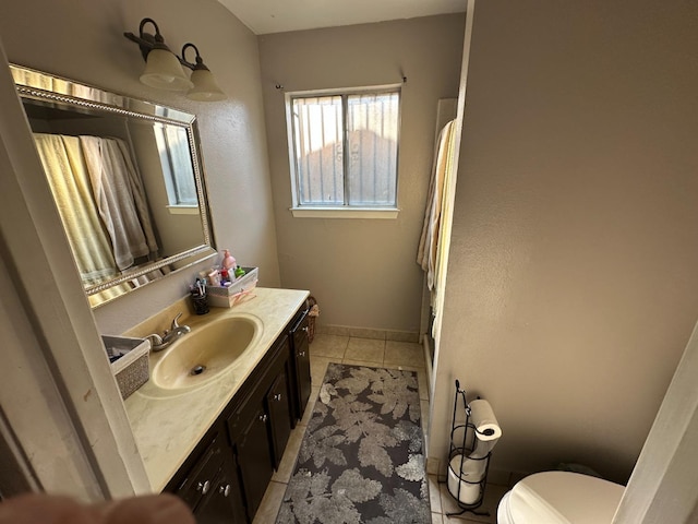 bathroom featuring toilet, tile patterned flooring, and vanity