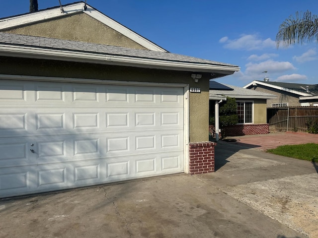 exterior space featuring fence and concrete driveway