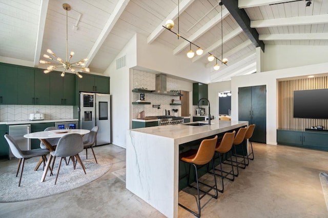 2460 W Browning Ave, Fresno, CA 93711 - kitchen with a notable chandelier, a sink, green cabinets, stainless steel refrigerator with ice dispenser, and wall chimney exhaust hood